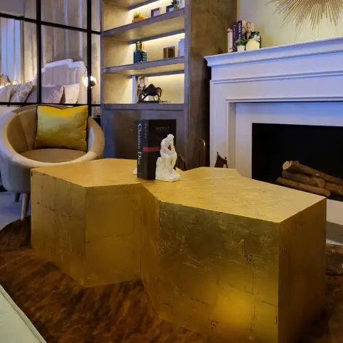 Pure golden casa deco center table by fireplace